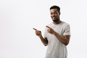 cheerful african american man pointing with fingers and smiling isolated on white