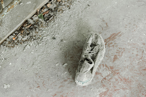 top view of abandoned and dirty shoe on floor