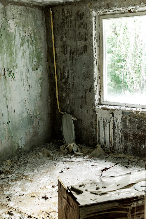 selective focus of damaged and dirty room in empty home in chernobyl