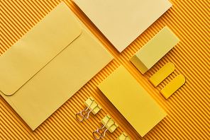 top view of arranged office stationery supplies on yellow