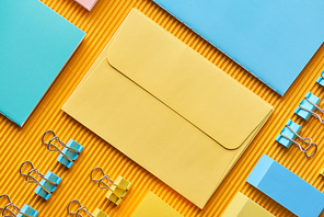 flat lay of multicolored arranged stationery supplies on yellow