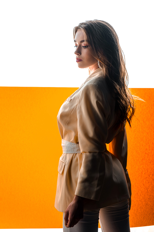 young beautiful woman in blazer with belt on orange and white