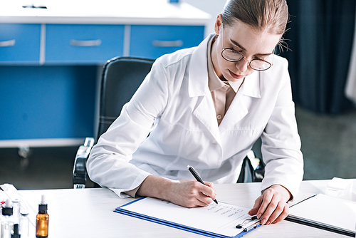 attractive allergist holding pen near clipboard with checklist