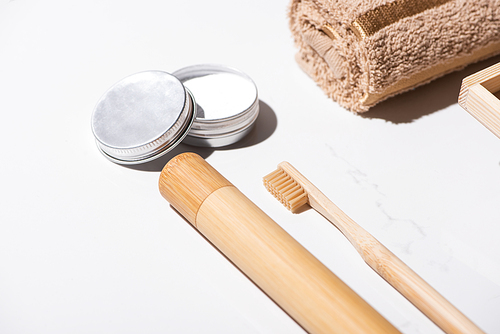 Toothbrush case, toothbrush, towel and jar of wax on white background, zero waste concept