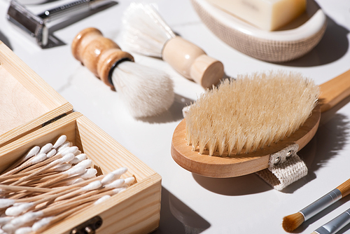 Selective focus of shaving brushes, box of ear sticks, Hair brush on white background, zero waste concept