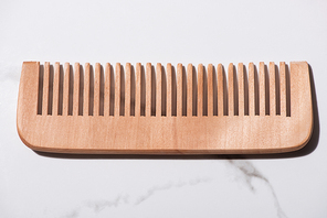 Close up of wooden comb on white background, zero waste concept