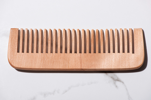 Close up of wooden comb on white background, zero waste concept