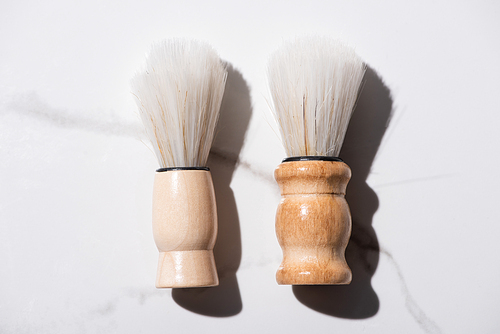 Top view of shaving brushes on white background, zero waste concept