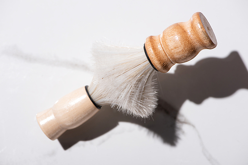 Top view of connected shaving brushes on white background, zero waste concept