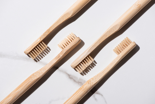Top view of wooden toothbrushes on white background, zero waste concept