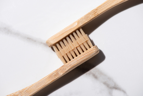 Top view of connected toothbrushes on white background, zero waste concept