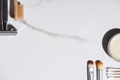 Top view of cosmetic brushes, toothbrush, razor, jar of wax and ear sticks on white background, zero waste concept