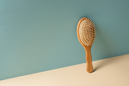 Wooden hair brush on beige and grey, zero waste concept
