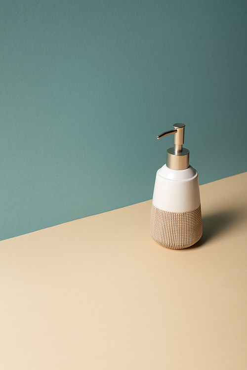 Liquid soap dispenser on beige and grey, zero waste concept