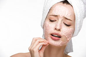 displeased girl removing peeling mask from face isolated on white