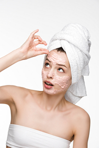 dissatisfied girl removing scrab mask from face while  isolated on white