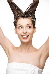 happy girl looking away while washing long hair isolated on white