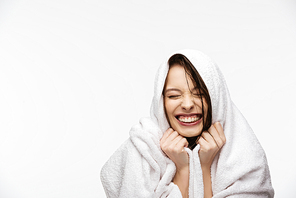 excited girl, wrapped in towel, smiling with closed eyes isolated on white