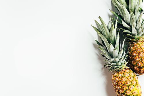 top view of fresh ripe pineapples on white background