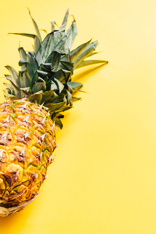 fresh ripe pineapple on yellow background