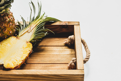 fresh cut pineapple on wooden tray on white background