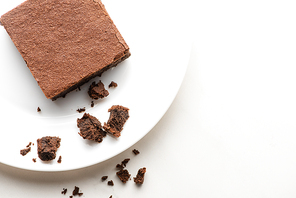 top view of delicious brownie piece on plate on white background