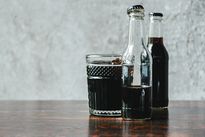 selective focus of cold brew coffee in bottles and glass