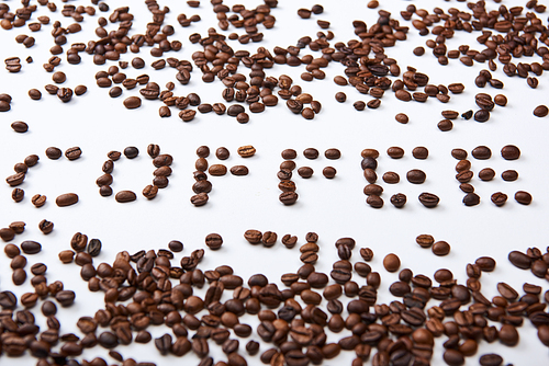 coffee lettering made of coffee beans on white background