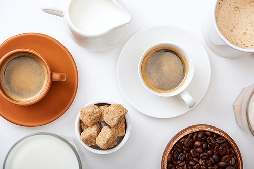 top view of coffee with milk and brown sugar on white background