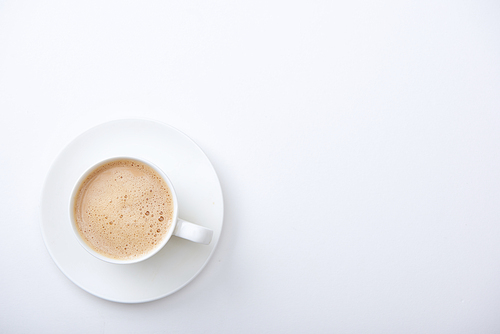 top view of delicious coffee with foam on white background with copy space