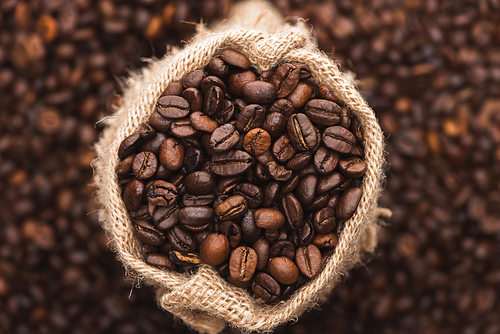 selective focus of fresh roasted coffee beans in sack