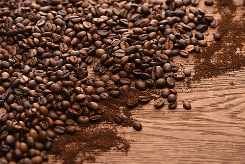 fresh roasted coffee beans and ground coffee on wooden table