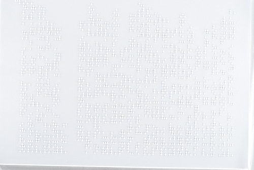 background of text in international braille code on white paper