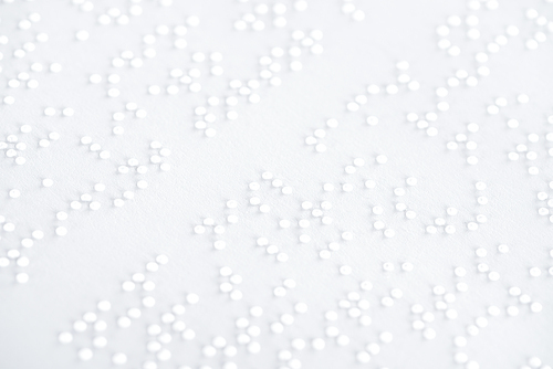 background of text in international braille code on white paper