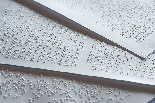 close up view of papers with international braille code