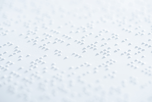close up view of text in international braille code on white paper
