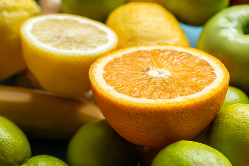 close up view of orange and lemon halves on fruits