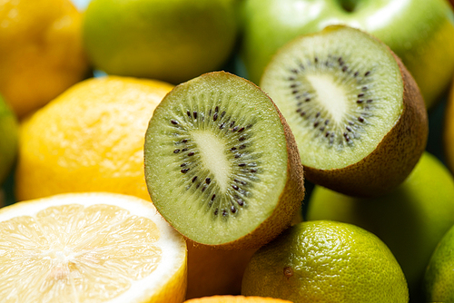 close up view of kiwi halves on lemons and limes