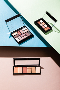 eye shadow palettes on blue, green and pink