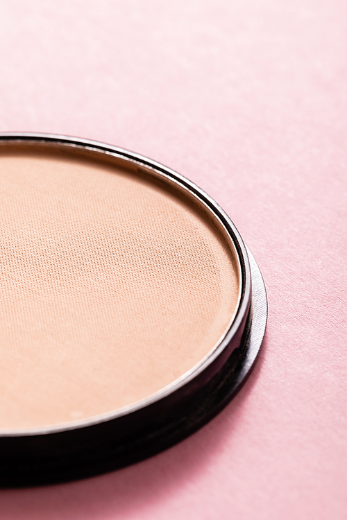 close up of face powder on pink