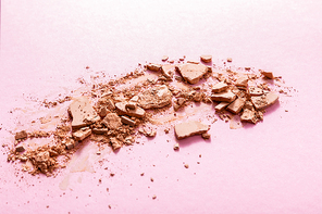 beige and cracked face powder on pink