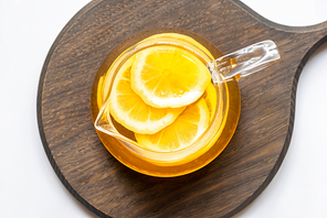 top view of hot tea with lemon slices on wooden board on white background