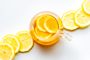 top view of hot tea with lemon slices on white background