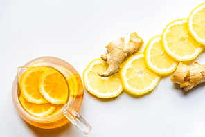 top view of hot tea with lemon and ginger on white background