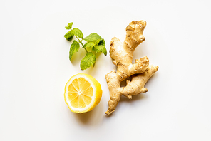 top view of ginger root, lemon and mint on white background