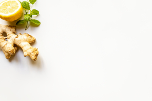 top view of ginger root, lemon and mint on white background