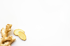 top view of whole ginger root and slices on white background