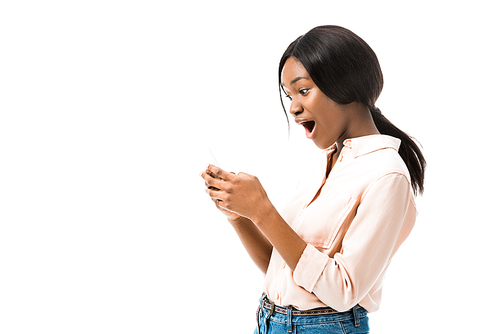 shocked african american woman holding smartphone isolated on white