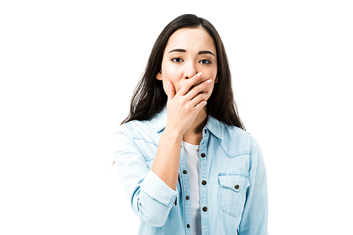 attractive and shocked asian woman in denim shirt  isolated on white