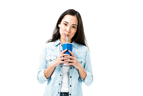 attractive asian woman in denim shirt drinking from plastic cup isolated on white